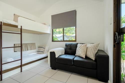 a living room with a couch and a bunk bed at Tasman Holiday Parks - Cairns Cool Waters in Cairns