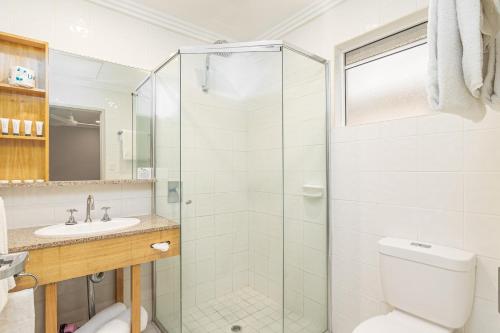 a bathroom with a shower and a toilet and a sink at Seahaven Resort in Townsville
