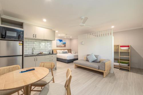a kitchen and a living room with a table and chairs at Seahaven Resort in Townsville