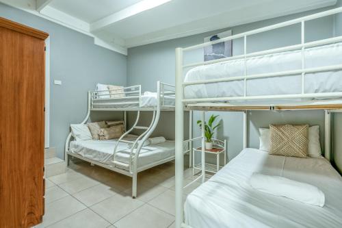 a room with two bunk beds and a bed at Tasman Holiday Parks - Cairns Cool Waters in Cairns