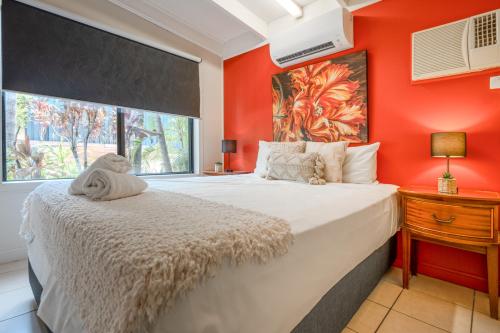 a bedroom with a large bed and a window at Tasman Holiday Parks - Cairns Cool Waters in Cairns