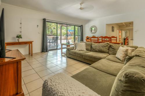 a living room with a couch and a table at Tasman Holiday Parks - Cairns Cool Waters in Cairns