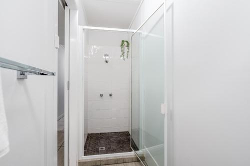 a shower with a glass door in a bathroom at Tasman Holiday Parks - Cairns Cool Waters in Cairns
