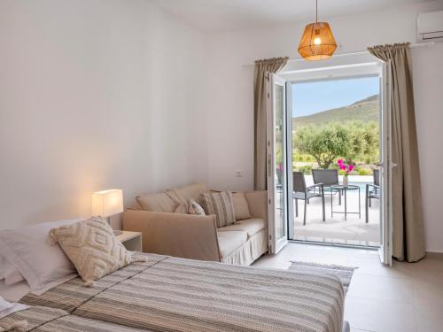 a bedroom with a bed and a living room at Amouage Studios in Kampos Paros