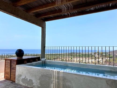 a swimming pool with a view of the ocean at Casa Chiquilluma in Piedra Blanca