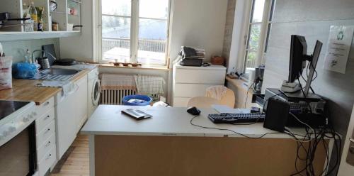 a kitchen with a desk with a computer on it at The Catch in Køge