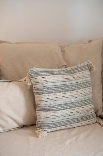 a blue and white crochet pillow on a couch at Amouage Studios in Kampos Paros