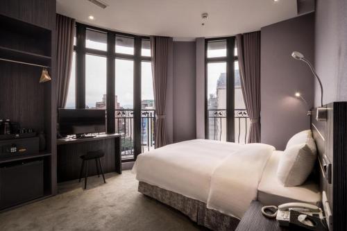 Postel nebo postele na pokoji v ubytování Yi Su Hotel-Taipei Ningxia