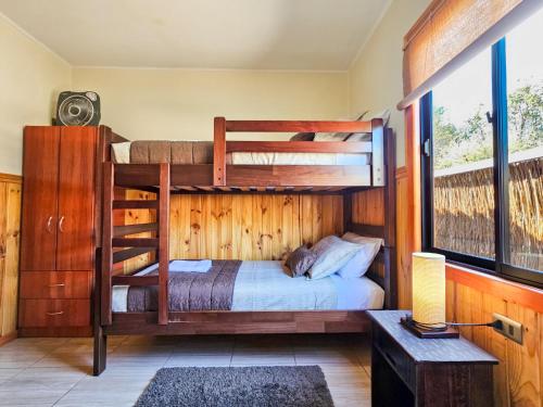 a bedroom with two bunk beds in a house at Lodge Ancar Atacama in San Pedro de Atacama