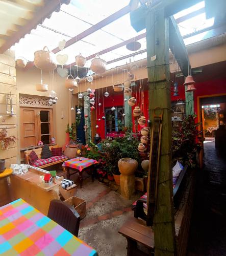 a living room with a table and chairs and a room with at Mi Casa es tu Casa Inn in Chiquinquirá