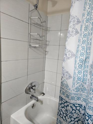 a bathroom with a sink and a shower curtain at Necessary Retreat in Orlando