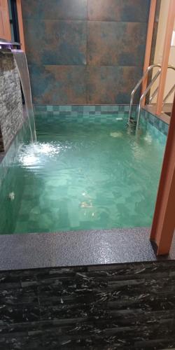 a swimming pool with a water fountain in it at Eden Cottage in Cochin