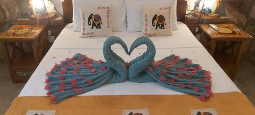 a bed with a cake with two hearts on it at Villa Olde Ceylon in Kandy