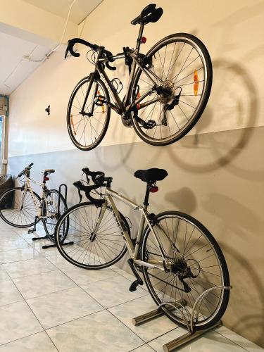 a group of bikes hanging on a wall at ห้องพักโอบอ้อมอารีย์ Orb Aom Aree in Hua Hin