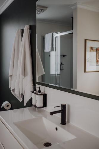 a bathroom with a sink and a mirror at Little Talisker in Stanley