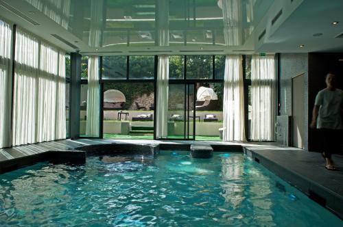 a large swimming pool with a large tub at Best Western Premier Grand Monarque Hotel & Spa in Chartres