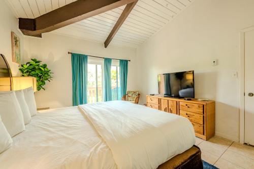 a bedroom with a large bed and a television at Seagulls Serenade Cozy 1BR Hideaway near Beach 206 in South Padre Island