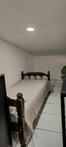 a bedroom with a bed in a white room at Apartamento Confort Loft 01 in Ponta Porã