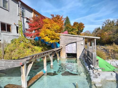 a house with a bridge over a pool of water at Sawa no Yado Kinsenkaku - Vacation STAY 45272v in Date