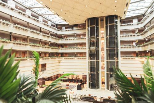 an image of a large building with plants in the foreground at Kyoto Brighton Hotel in Kyoto