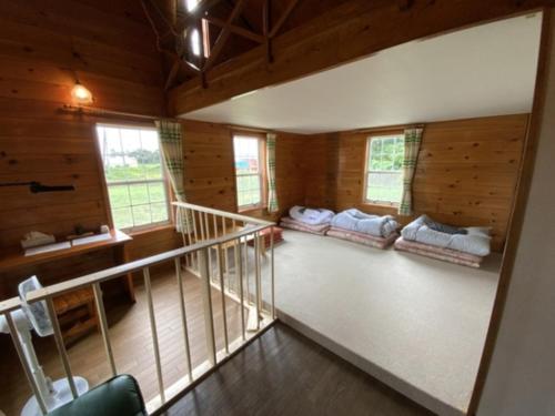 a room with a staircase in a wooden house at Mashuko Youth Hostel - Vacation STAY 01017v in Teshikaga