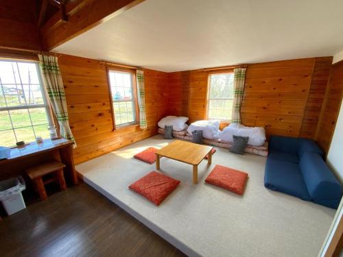 a living room with a couch and a table at Mashuko Youth Hostel - Vacation STAY 01017v in Teshikaga