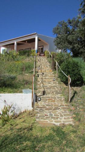 a set of stone stairs in front of a house at Cerca da Ponte in Almodôvar