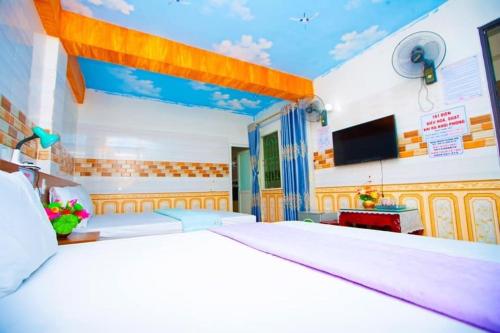 a bedroom with a large bed and a flat screen tv at Hưng Hà Hotel DB - by BAY LUXURY in Diện Biên Phủ