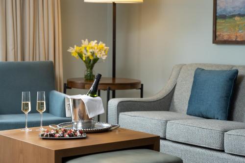 a living room with a couch and a table with wine glasses at Meadowbrook Inn in Blowing Rock