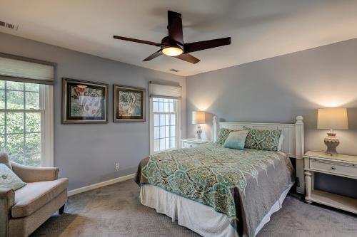 a bedroom with a bed and a ceiling fan at Evian 156 in Hilton Head Island
