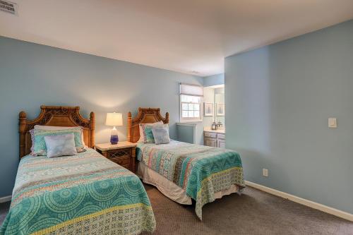 two beds in a bedroom with blue walls at Evian 156 in Hilton Head Island