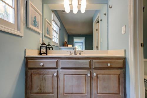 a bathroom with a sink and a mirror at Evian 156 in Hilton Head Island