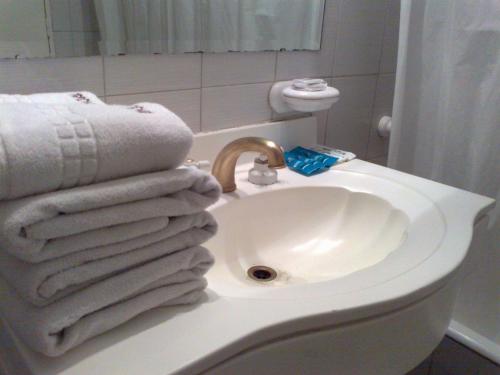 a bathroom with a sink with towels on it at Tritone Hotel in Buenos Aires