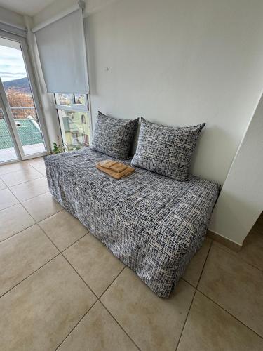 a bed with pillows in a room with a window at Rincón Montañas del Sur in Ushuaia