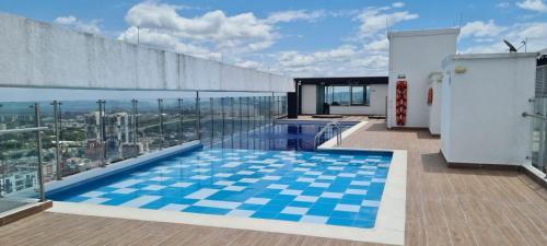a swimming pool on the roof of a building at Estadía Familiar in Ibagué
