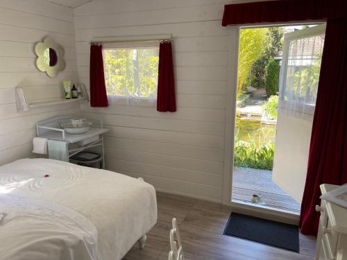 a bedroom with a bed and a sliding glass door at Teichhäuschen Cyprinus in Aarau