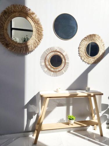 a room with three mirrors and a wooden table at Semipiso Las Lomitas in Lomas de Zamora