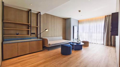 a living room with a couch and a table at EVEN Hotel Yinchuan Yuehai by IHG in Yinchuan