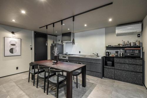 a kitchen with a table and chairs in a room at JAPAVISTA Radiant in Osaka