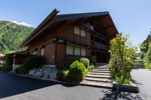 a large building with stairs leading up to it at Chalet Résidence Chantey Mourry in Argentiere