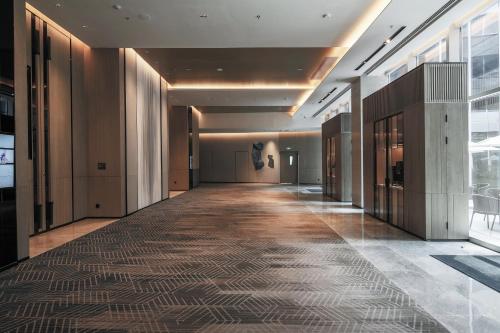 an empty hallway in a building with a long corridor at AC Hotel by Marriott Chengdu North in Chengdu