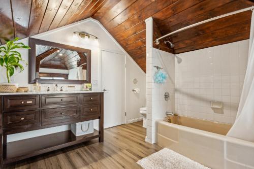 a bathroom with a sink and a tub and a mirror at Beautiful Spacious Victorian Garden Oasis Central, Gated, Deck, BBQ in San Rafael