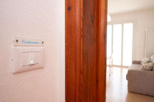 a light switch on a wall in a room at Appartamento Conturrana Sul Mare in San Vito lo Capo