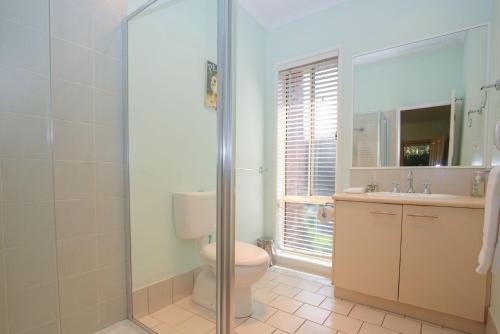 a bathroom with a toilet and a sink and a shower at Silver Birches Holiday Village - Unit 3 in Bright
