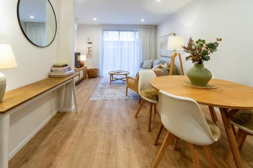 a living room with a dining table and a living room at Stylish 3 Bedroom Home in Prime City with Garage in Christchurch