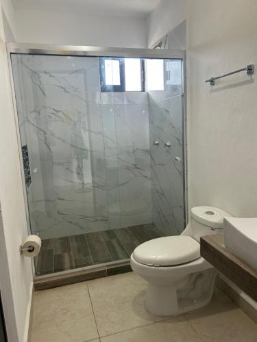 a bathroom with a shower and a toilet and a sink at Departamento en Mazatlán in Mazatlán