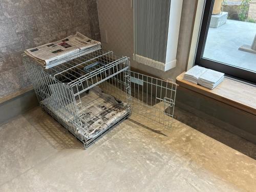 a cage with newspapers in it next to a window at East Villa Shimanami Mukaishima seafront in Onomichi
