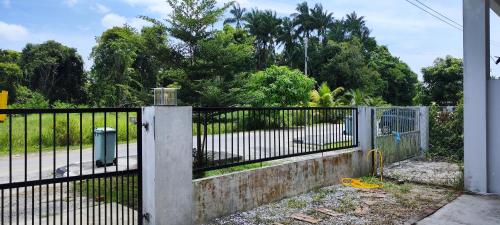 an iron fence with a gate in a yard at Farwis Homestay in Mukah