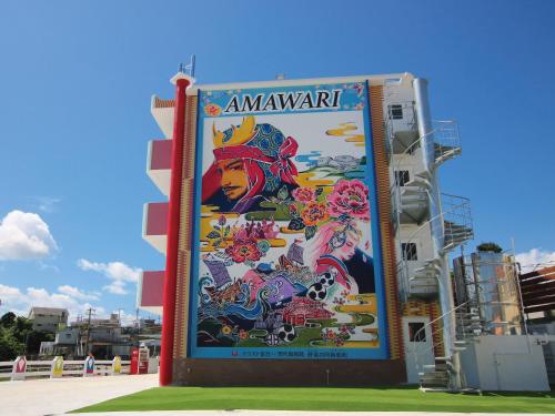 a large mural on the side of a building at AMAWARI HOTEL -SEVEN Hotels and Resorts- in Uruma