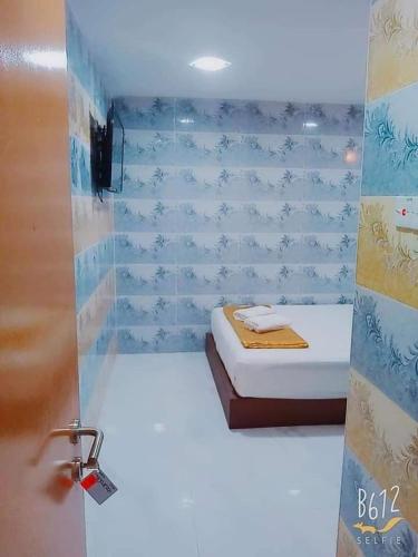a bathroom with a bed in a room at ARK Malacca Hotel in Malacca